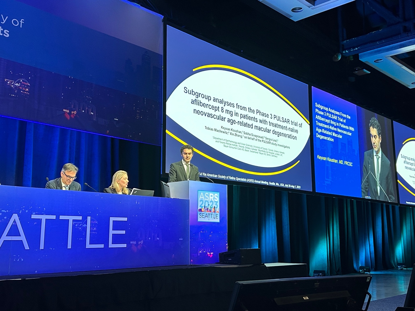 A group of people at a podium Description automatically generated