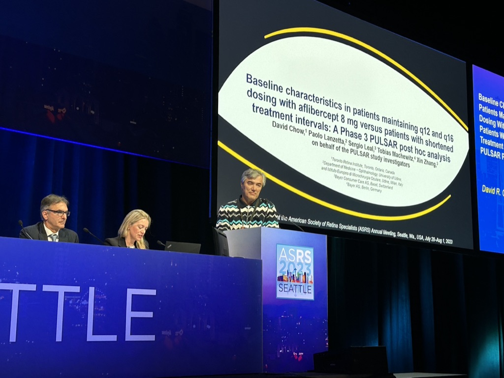 A group of people at a podium Description automatically generated