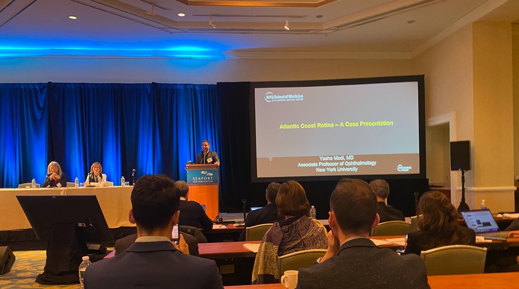 A group of people in a room Description automatically generated with low confidence