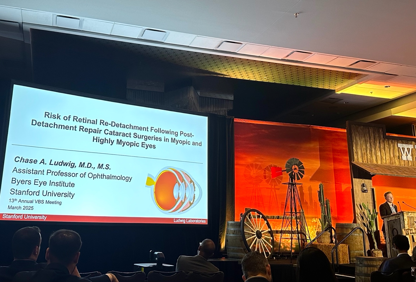 A group of people in front of a screen Description automatically generated