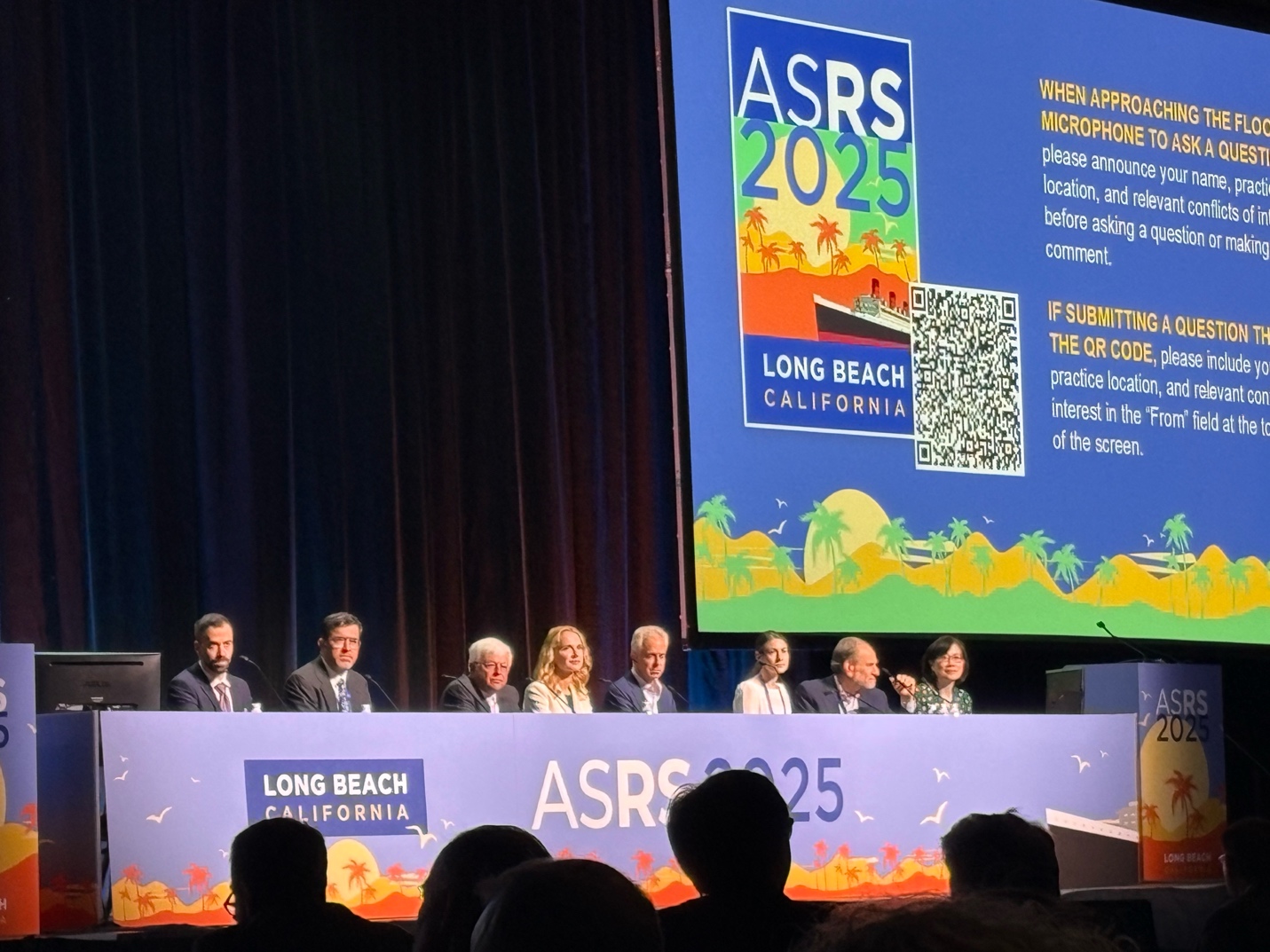 A group of people on a stage AI-generated content may be incorrect.