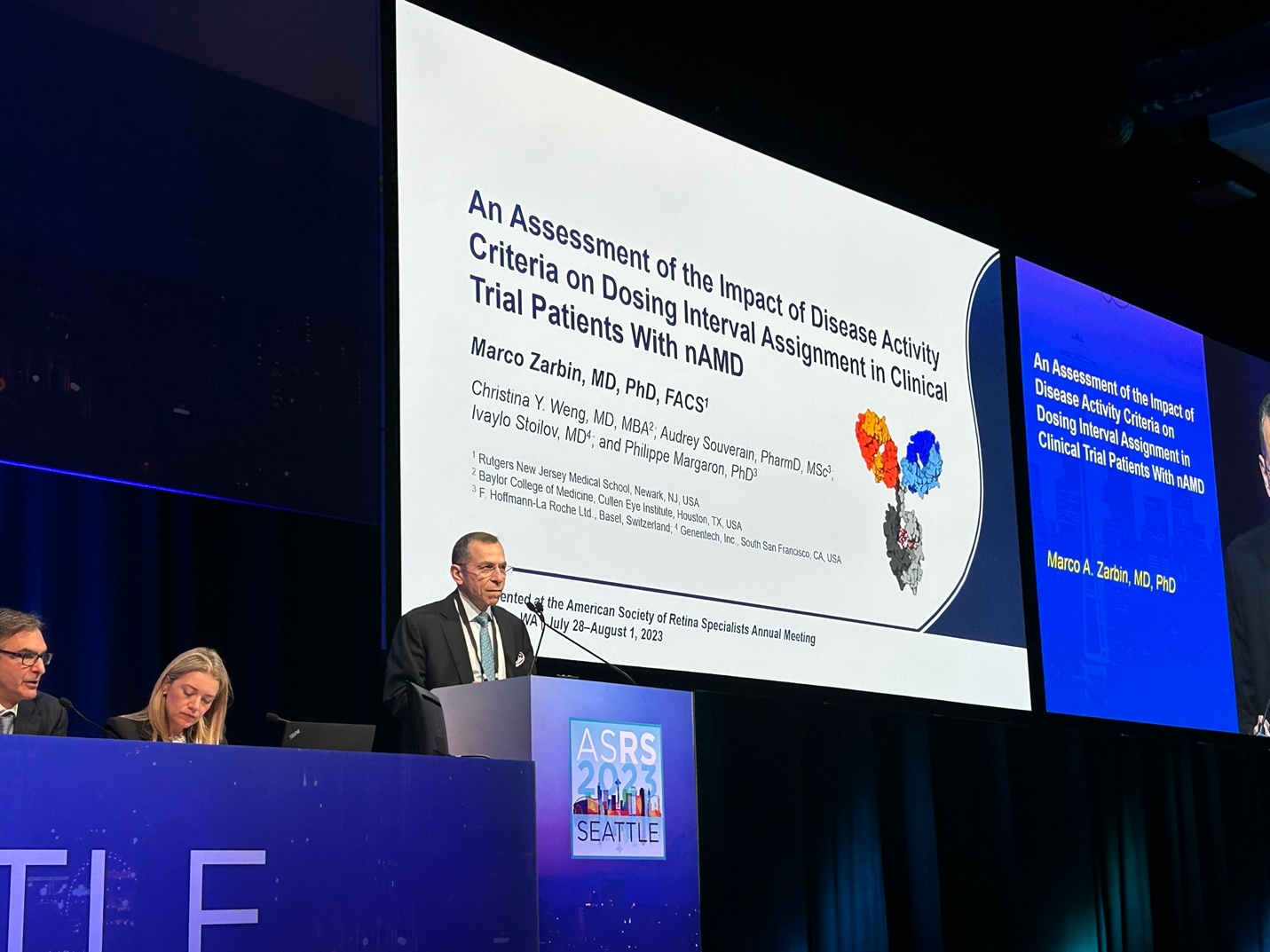 A person and person at a podium Description automatically generated