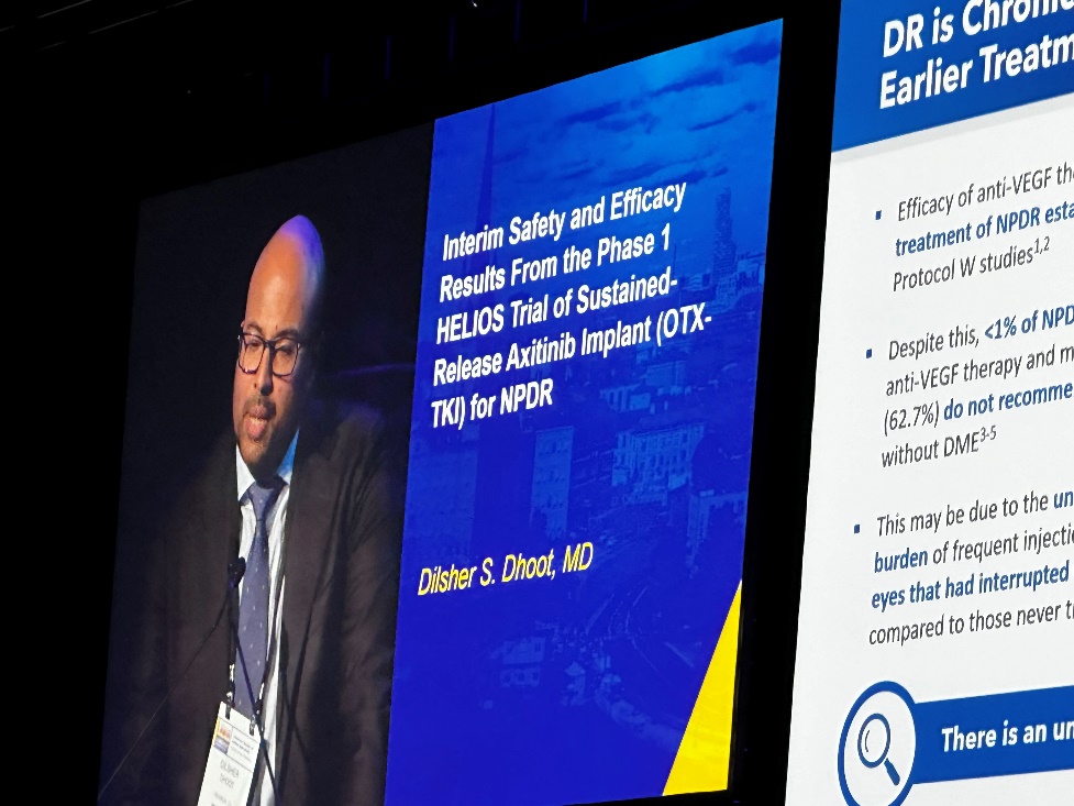 A person in a suit and tie on a screen Description automatically generated