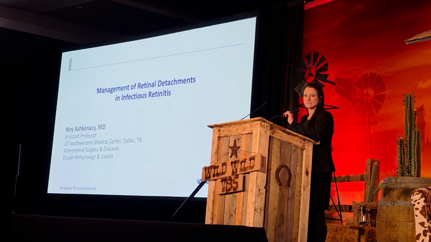 A person standing at a podium Description automatically generated