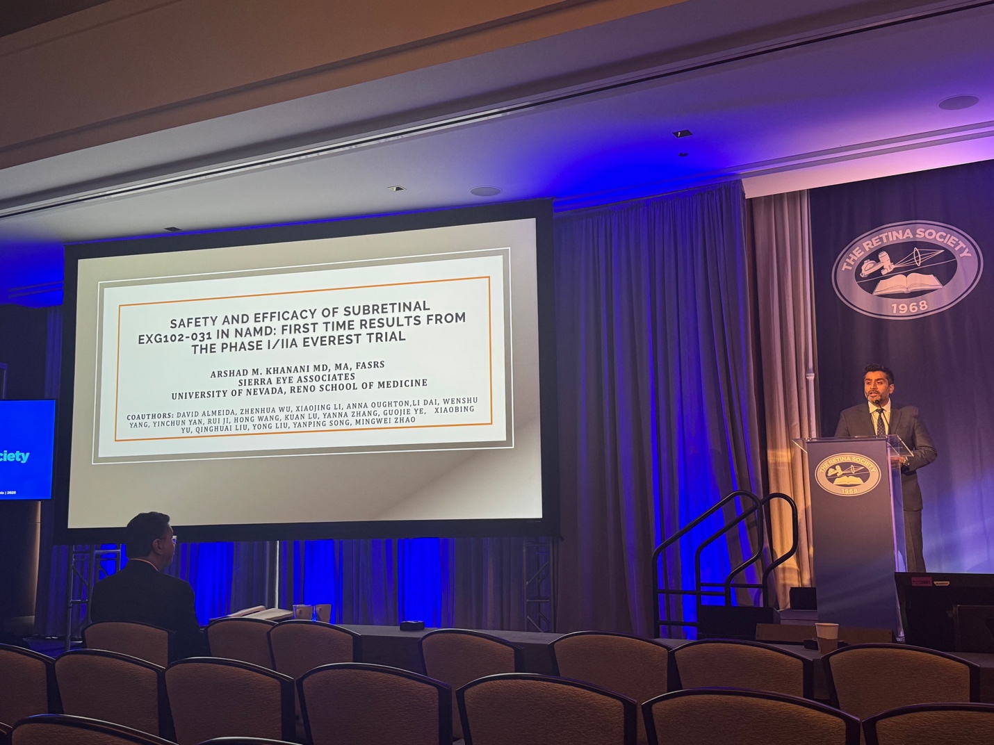 A person standing at a podium with a projector screen AI-generated content may be incorrect.