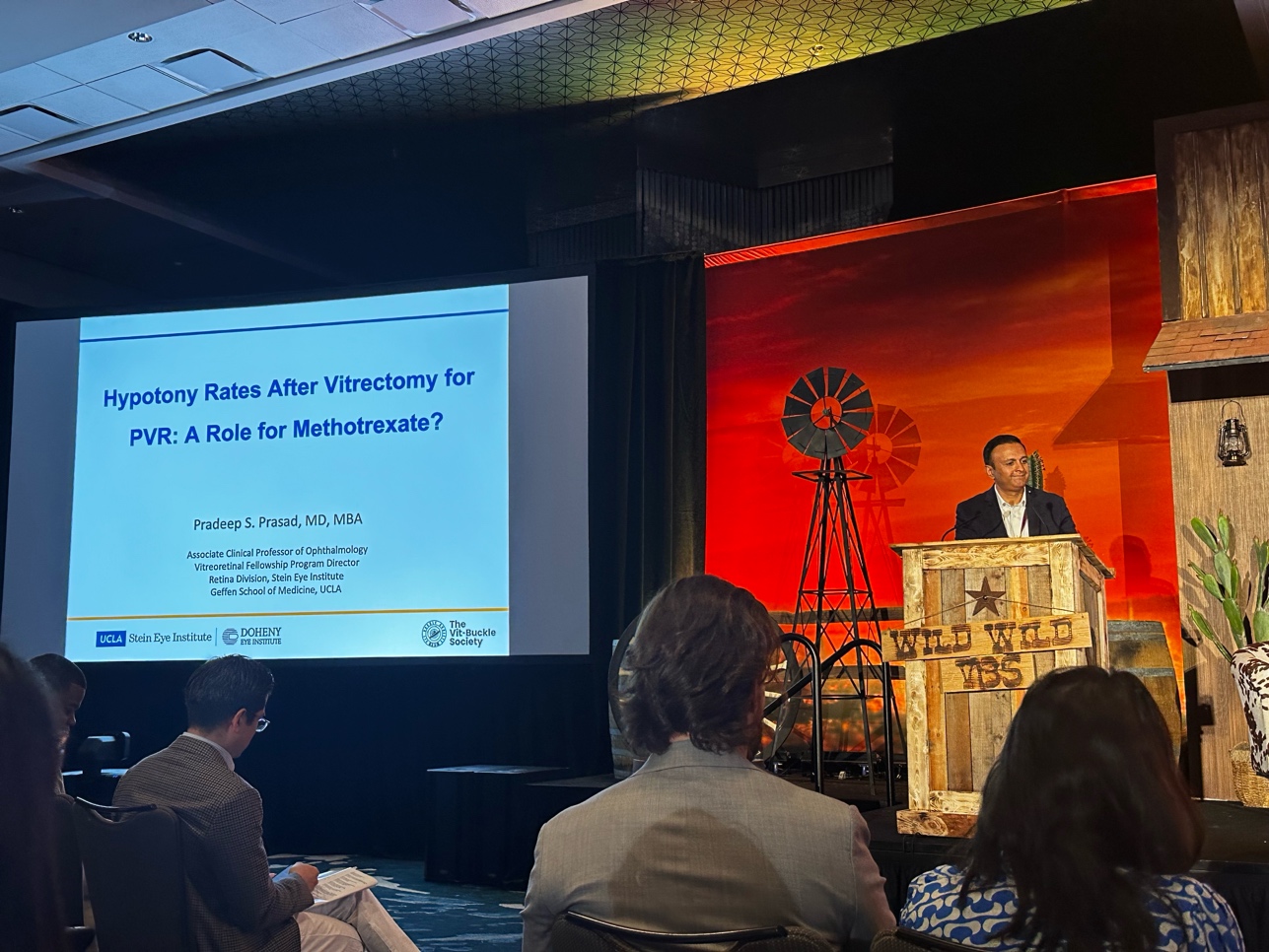 A person standing at a podium with a screen on the side AI-generated content may be incorrect.