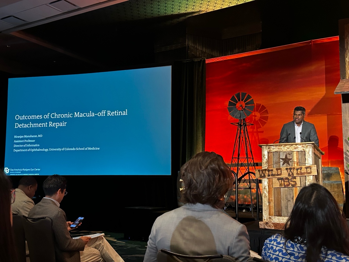 A person standing at a podium with a screen on the side AI-generated content may be incorrect.