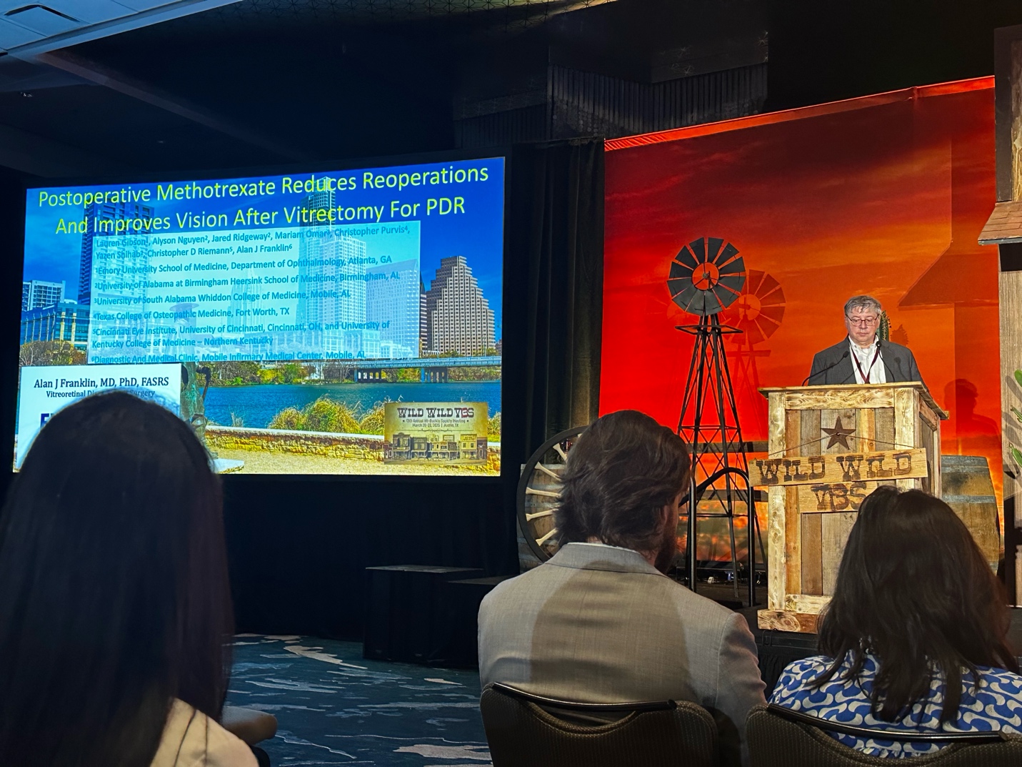 A person standing in front of a large screen AI-generated content may be incorrect.