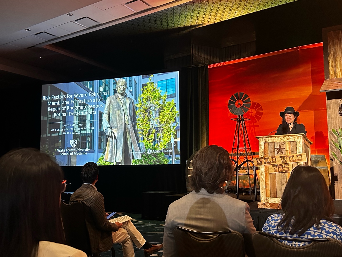 A person standing in front of a large screen AI-generated content may be incorrect.